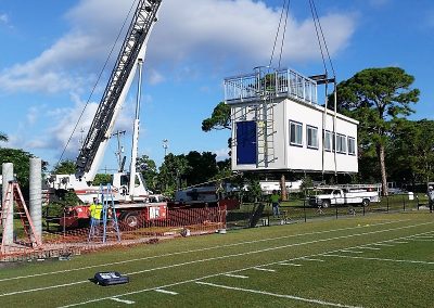 Crane lifting modular pressbox