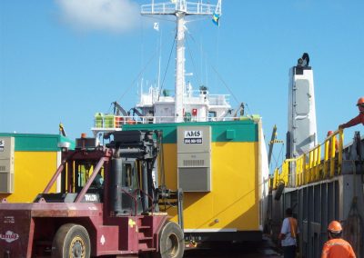 Truck moving modular building from ship in Nassau